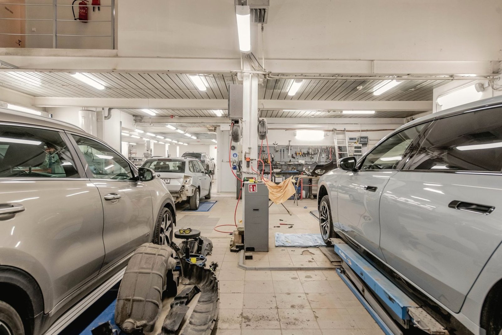 A bright repair shop with cars in service bays