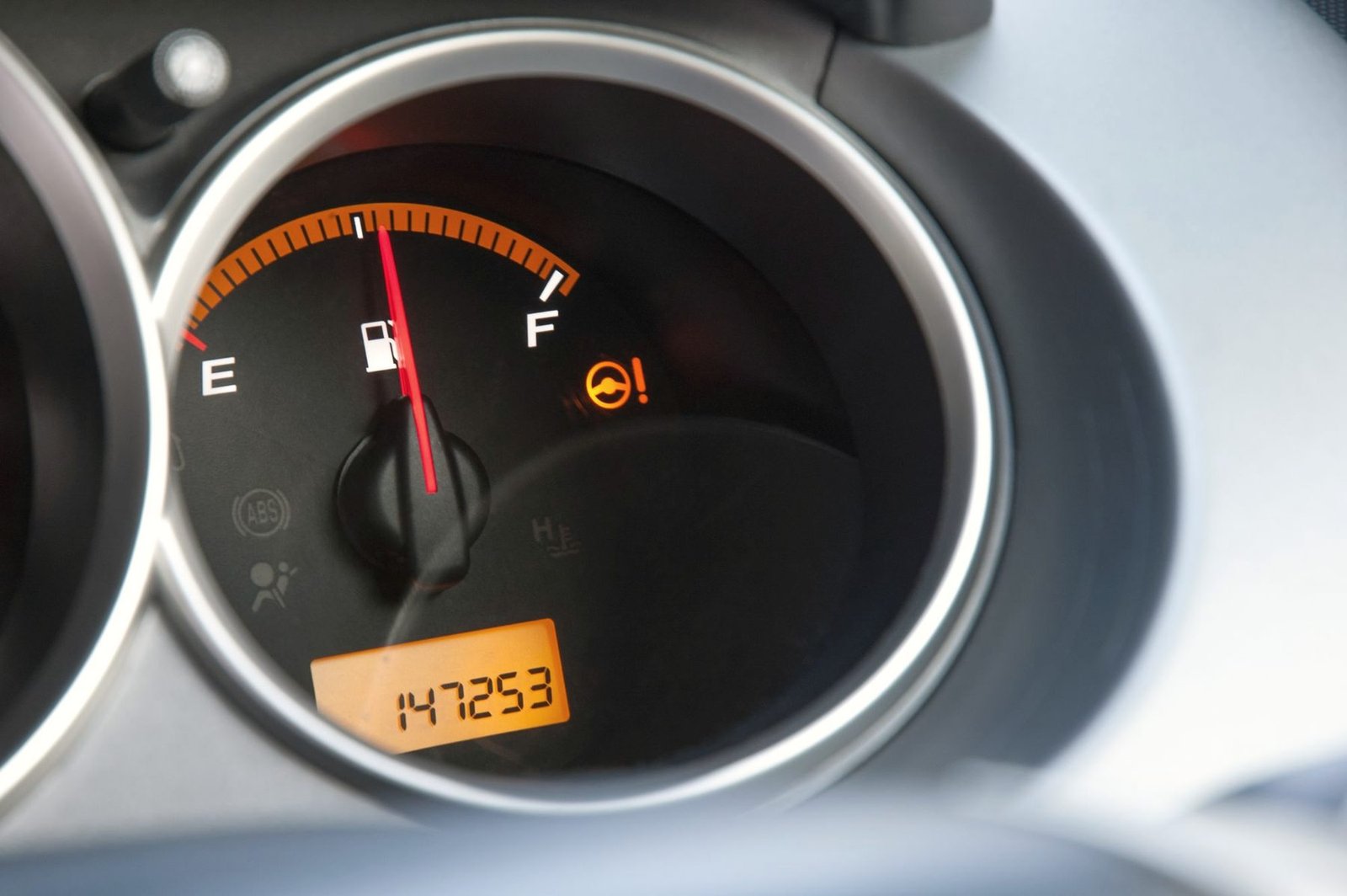 A fuel gauge and odometer reading 147,253 miles