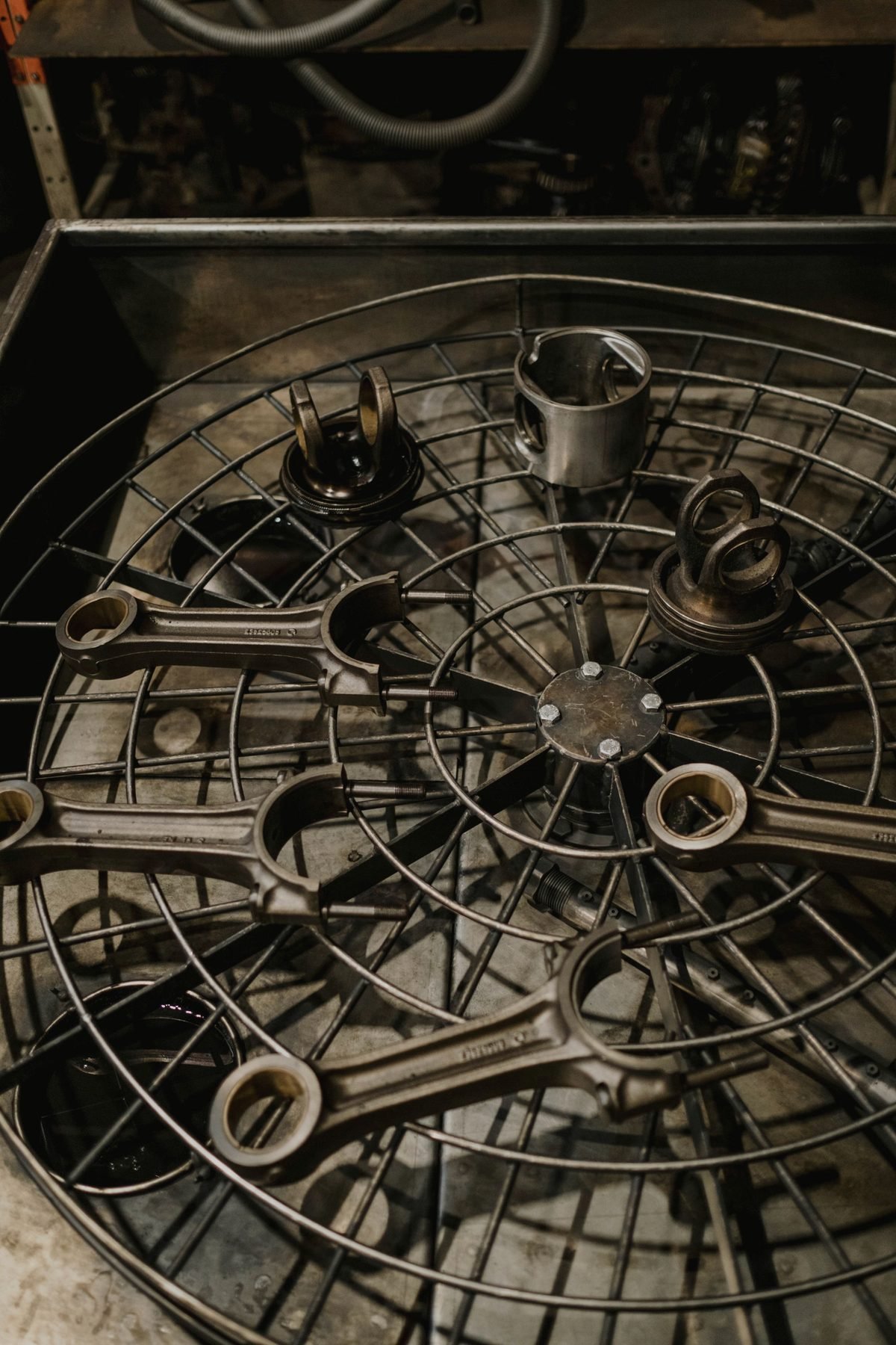 Metal drivetrain parts laid out on a grid